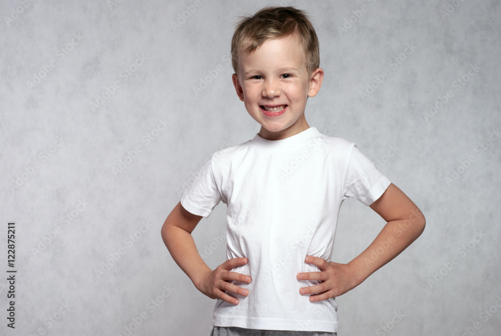 Portrait of a laughing boy on a grey background. Portrait of a laughing boy on a grey background.