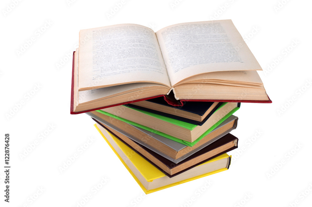 stack of multicolored books. One open. on white, isolated background. stack of multicolored books. One open. on white, isolated background.