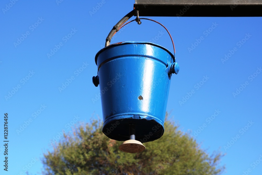 Blue shower bucket outdoors Stock Photo