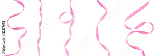 Lots of pink ribbons on a white, isolated background. Top view. Flat lay.