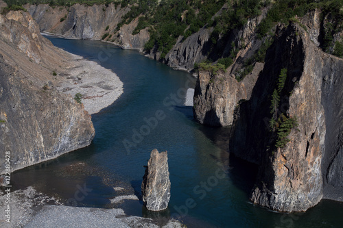 Single stone pillar in the riverbed. River Omulyovka. Magadan Region. Russia. photo