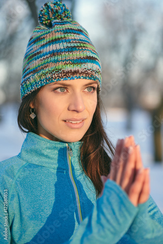 Attractive mixed race woman doing yoga in nature at winter time photo