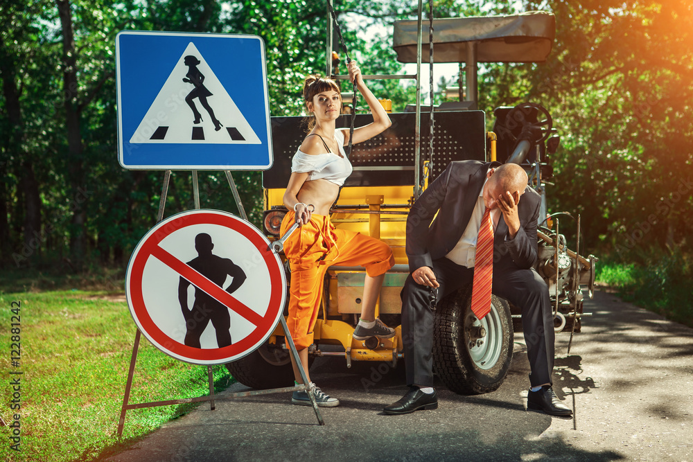 Woman worker with the wrench. Sad boss on the background. Woman worker with the wrench. Sad boss on the background.