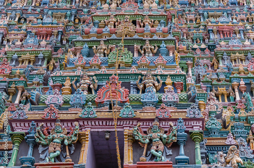 Madurai, India - October 19, 2013: Closeup of part of the North Gopuram facade. Among many more statues, two eight-armed Dwarapalakas.
