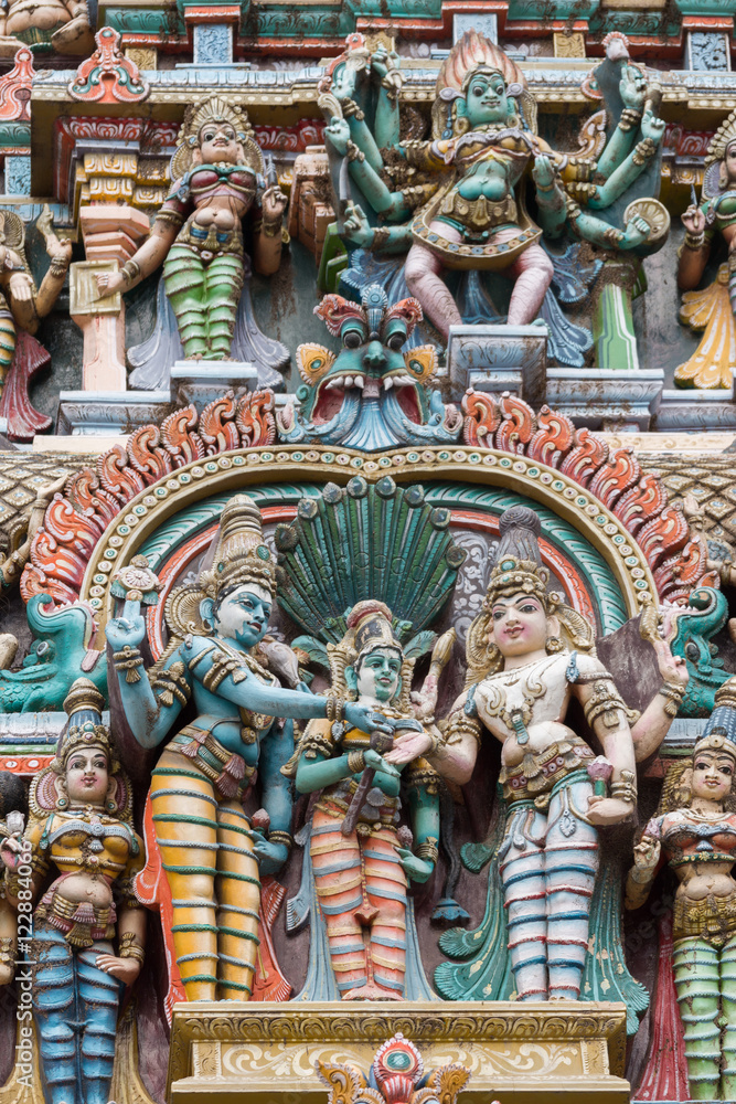 Madurai, India - October 19, 2013: Closeup of the wedding scene of Meenakshi and Shiva, while Vishnu gives his sister away. Facade of West Gopuram at Meenakshi Temple. Madurai, India - October 19, 2013: Closeup of the wedding scene of Meenakshi and Shiva, while Vishnu gives his sister away. Facade of West Gopuram at Meenakshi Temple.