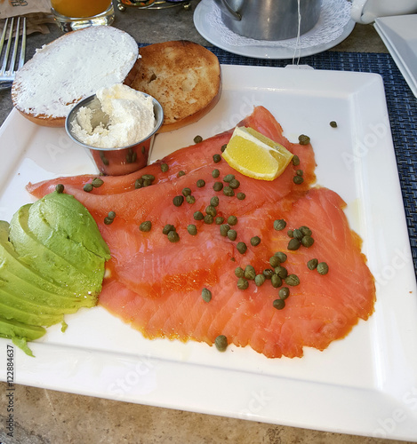 Bagel with salmon lox and cream cheese with avocado photo