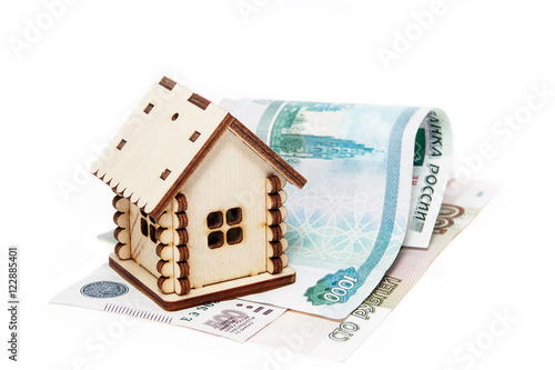 Wooden house and money on a white background