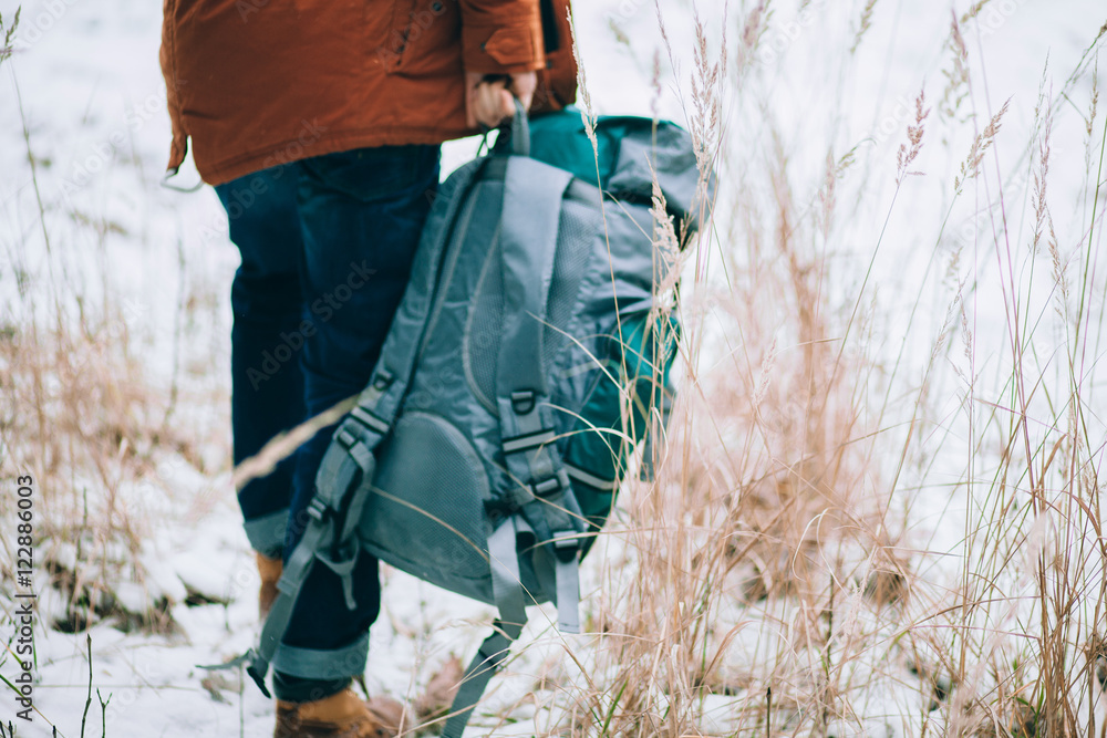 traveler with backpack in the winter forest traveler with backpack in the winter forest