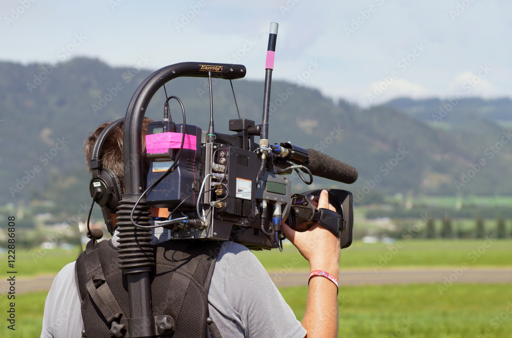 Naklejka premium Cameraman on an airfield
