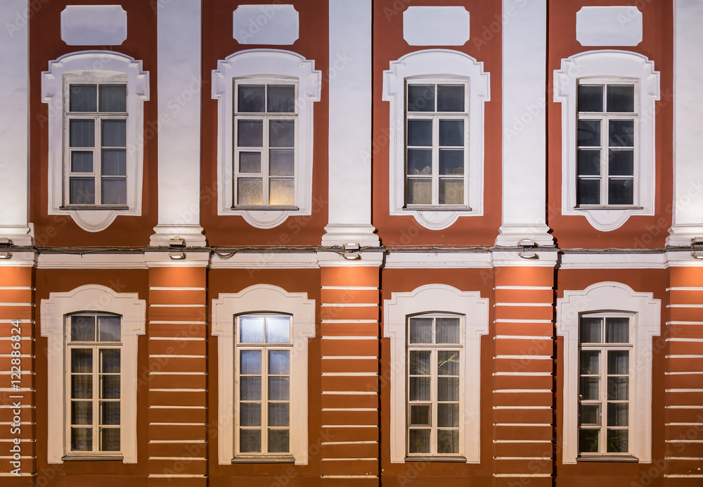 Obraz premium Several windows in a row on night illuminated facade of Saint Petersburg State University front view, Russia.
