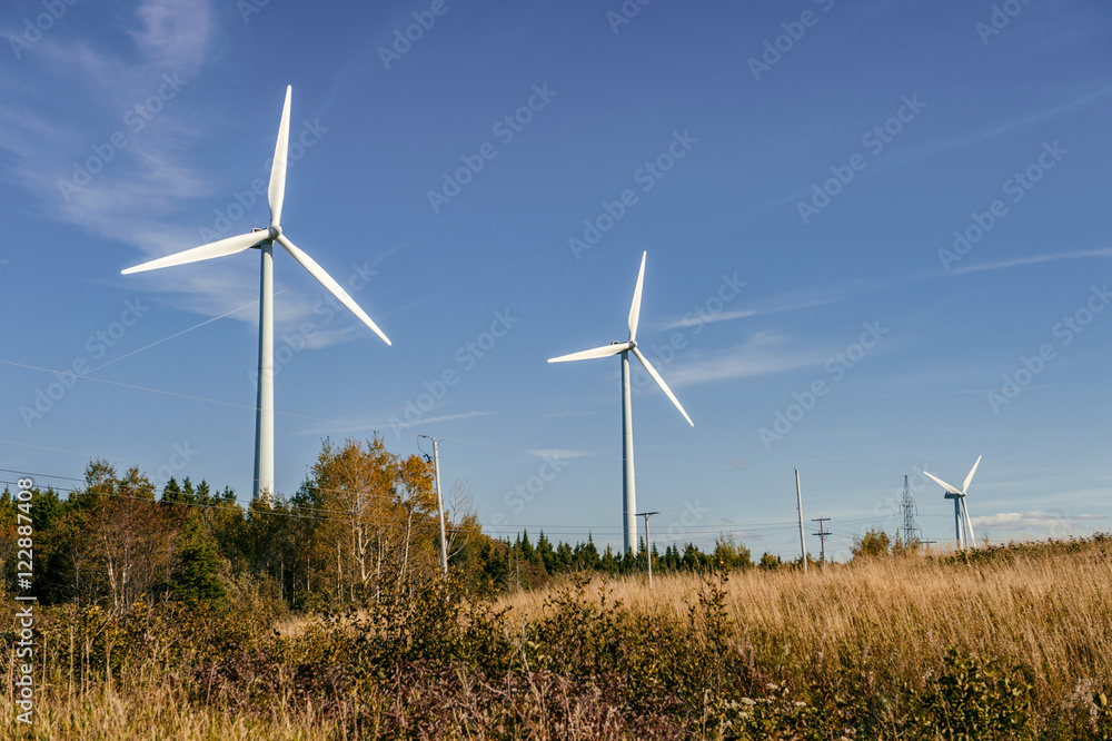 Wind turbine farm over blue sky at sunset Wind turbine farm over blue sky at sunset