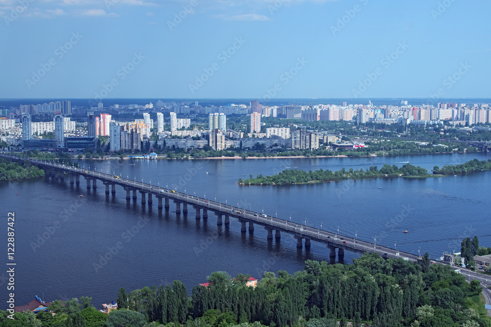 Kiev, Ukraine - 25 May 2015: Aerial view of the city buildings, Dnieper River and bridges from Monumental statue Mother Motherland