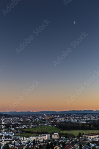skyline of Linz, Austria with mountains at sun dawn