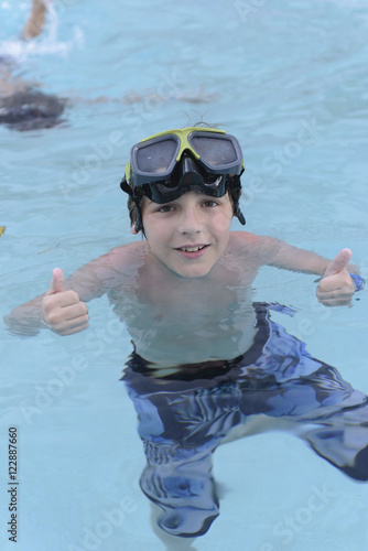 Boy enjoying the pool with diving goggles