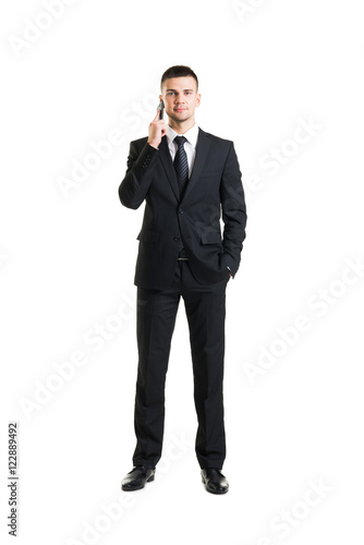 Young and confident business man with a telephone