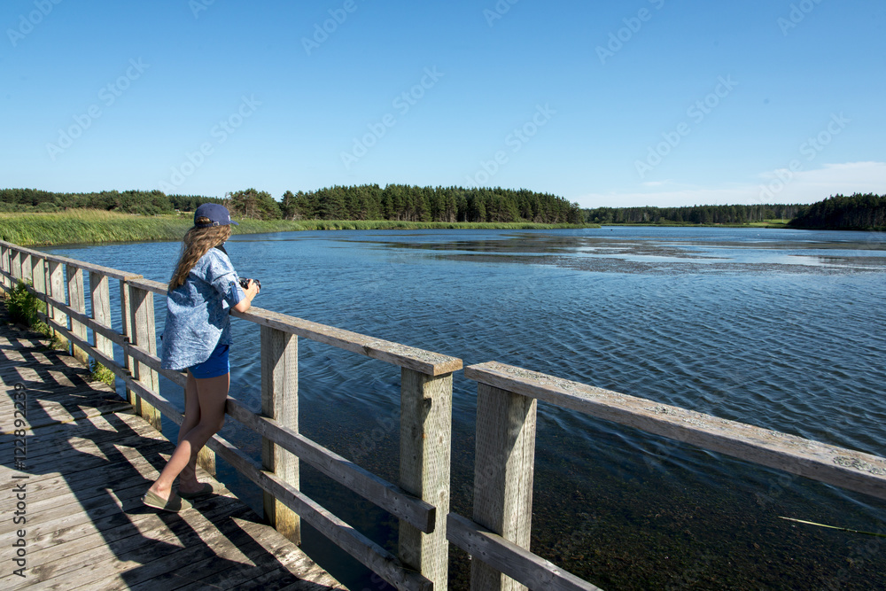 Girl standing on wooden bridge at Cavendish Dunelands Trail, Gre