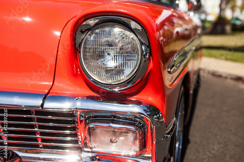 Part of a red old car with headlamp
