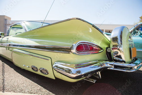 Part of a green vintage old car with headlamp