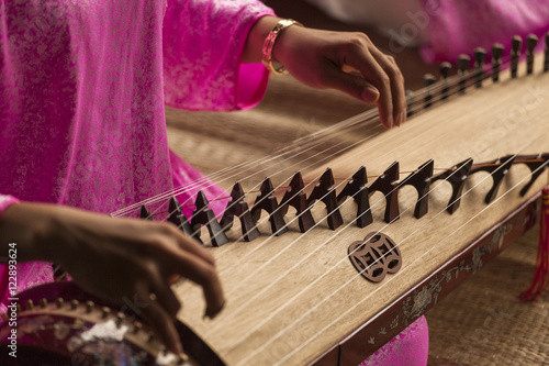 Woman play a traditional korean string instrument : the gayageum photo