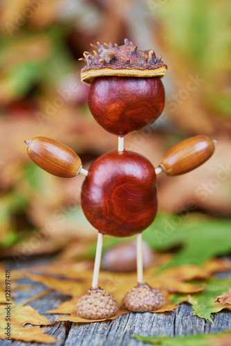 Small creature made of chestnuts and acorns. Autumnal decoration