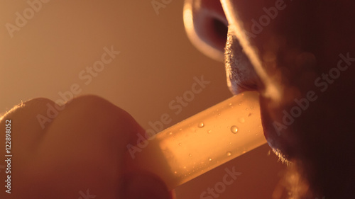 young bearded man smokes a hookah extreme close-up photo