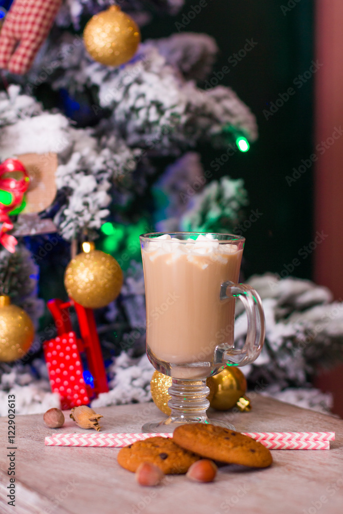 Hot cacao with marshmallows on old table on Christmas background