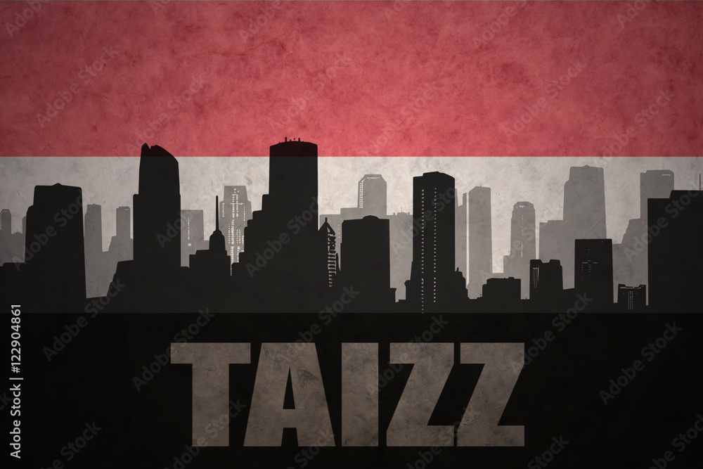 abstract silhouette of the city with text Taizz at the vintage yemen flag background