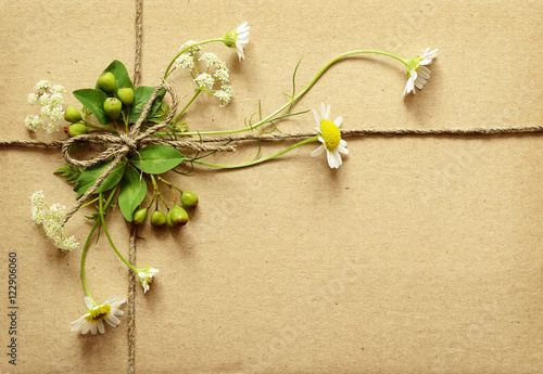 Wrapped box tied with daisy...