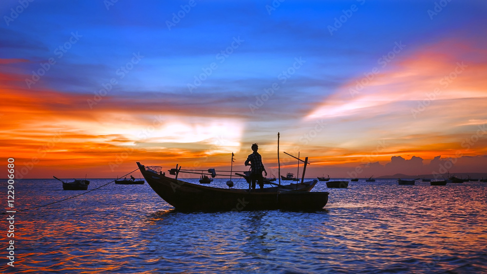 sea sunset with boat silhouette, man