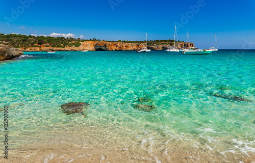 Mediterranean Sea coastline beach bay with boats at Cala Varques Majorca Spain © vulcanus