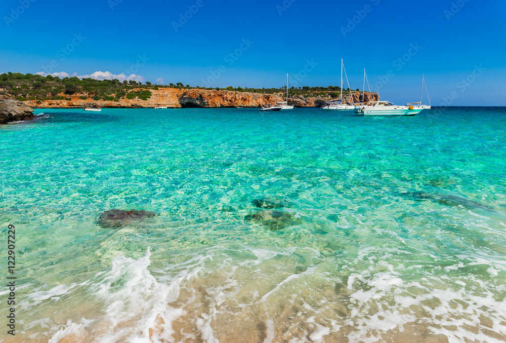 Boats anchored at sea coastline with turquoise water 