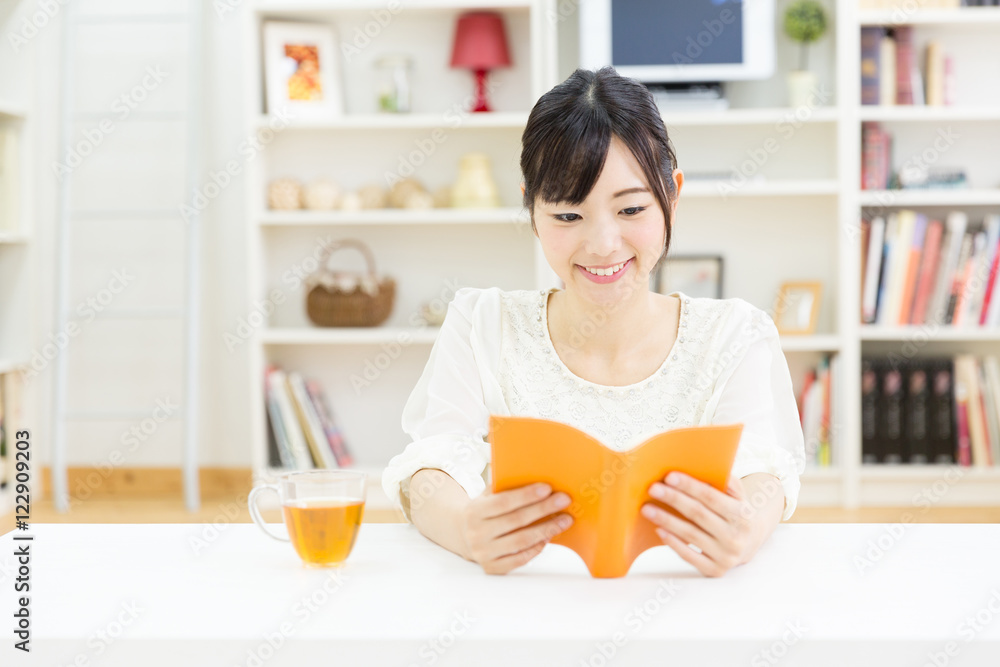 portrait of young asian woman reading book