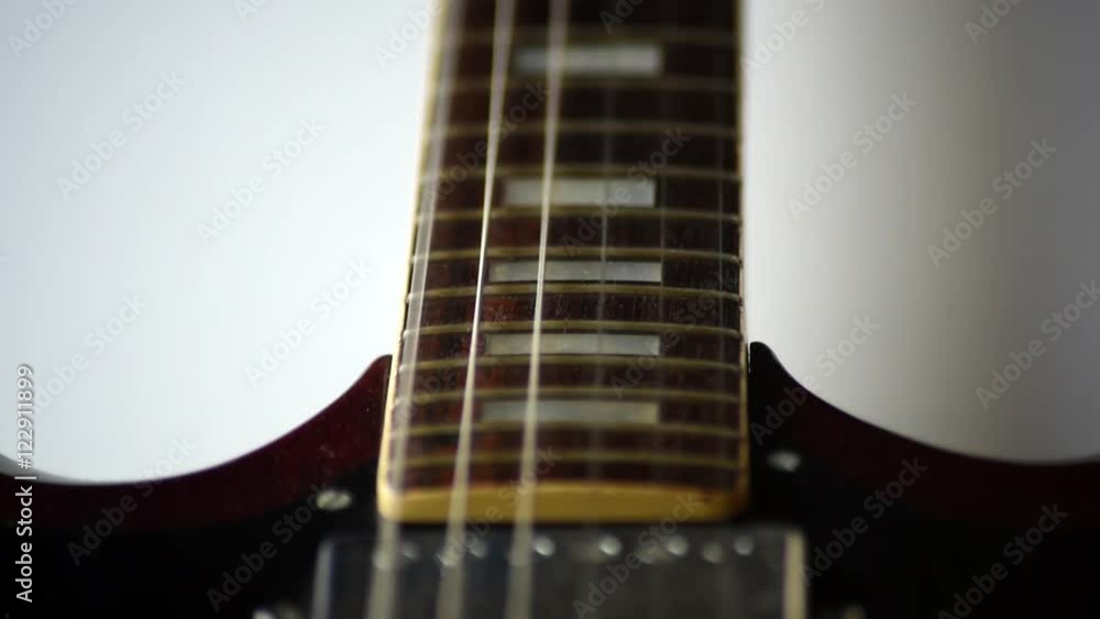 Closeup of guitar strings vibrating when being strummed Closeup of guitar strings vibrating when being strummed