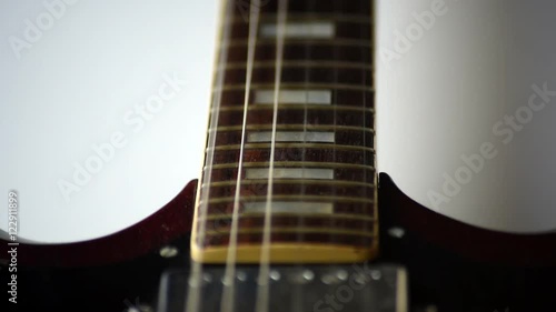 Closeup of guitar strings vibrating when being strummed