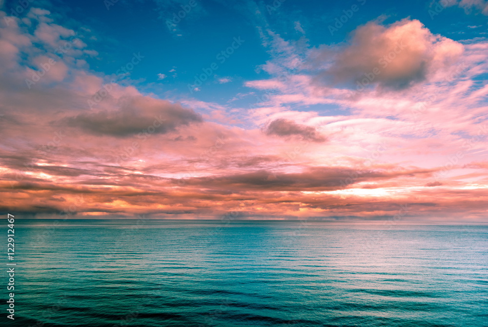 Multicolored surreal sunset view of a sea horizon. Beautiful landscape photography. Background tecture for travel and adventure.