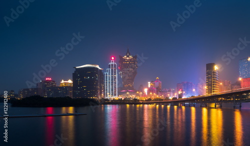 Skyline of Macau city at Nam Van Lake  China. The city maintains the world s highest gambling revenue with over 20 million tourists annually.
