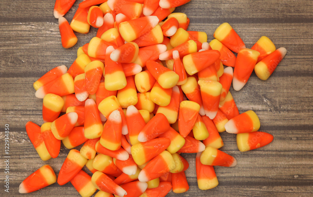 Candy Corn isolated on a Dark Wooden Table Candy Corn isolated on a Dark Wooden Table