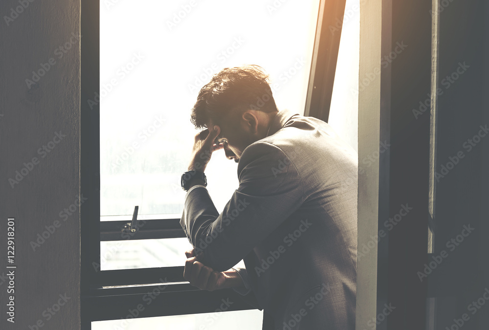 Courageous middle age man looking at the window,Sad and depressed businessman stand alone Courageous middle age man looking at the window,Sad and depressed businessman stand alone
