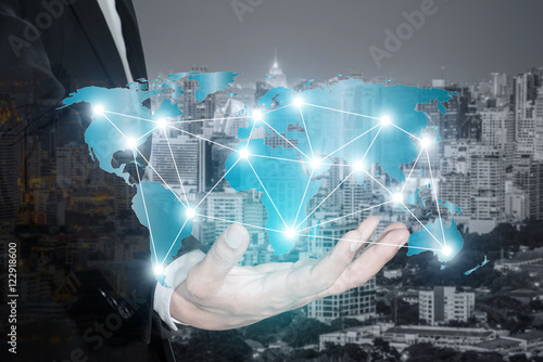 Global partnership network connection map on hand of businessman photo