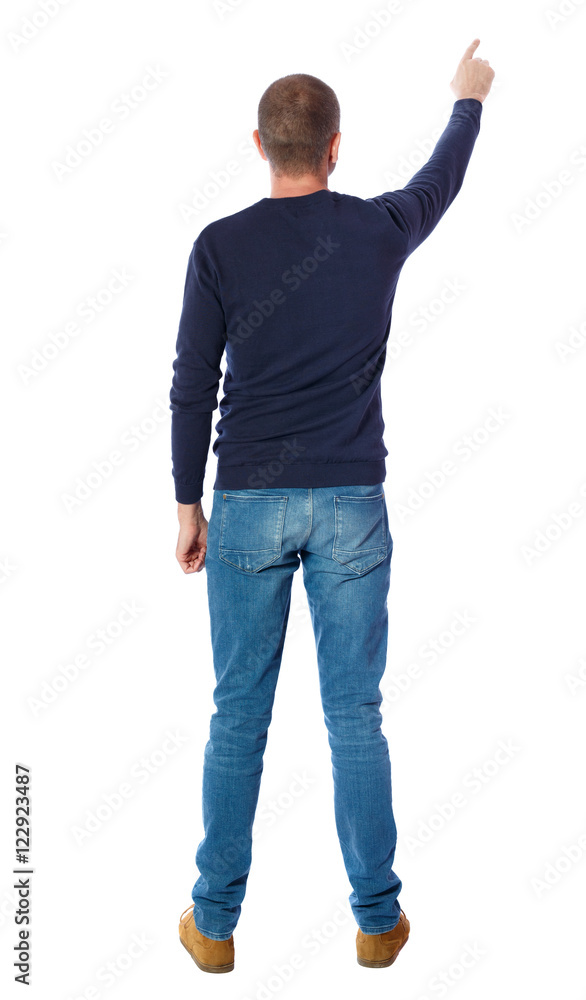 Back view of pointing young men in shirt and jeans. Young guy gesture. Rear view people collection. backside view of person. Isolated over white background. The guy in the black sweater is Back view of pointing young men in shirt and jeans. Young guy gesture. Rear view people collection. backside view of person. Isolated over white background. The guy in the black sweater is