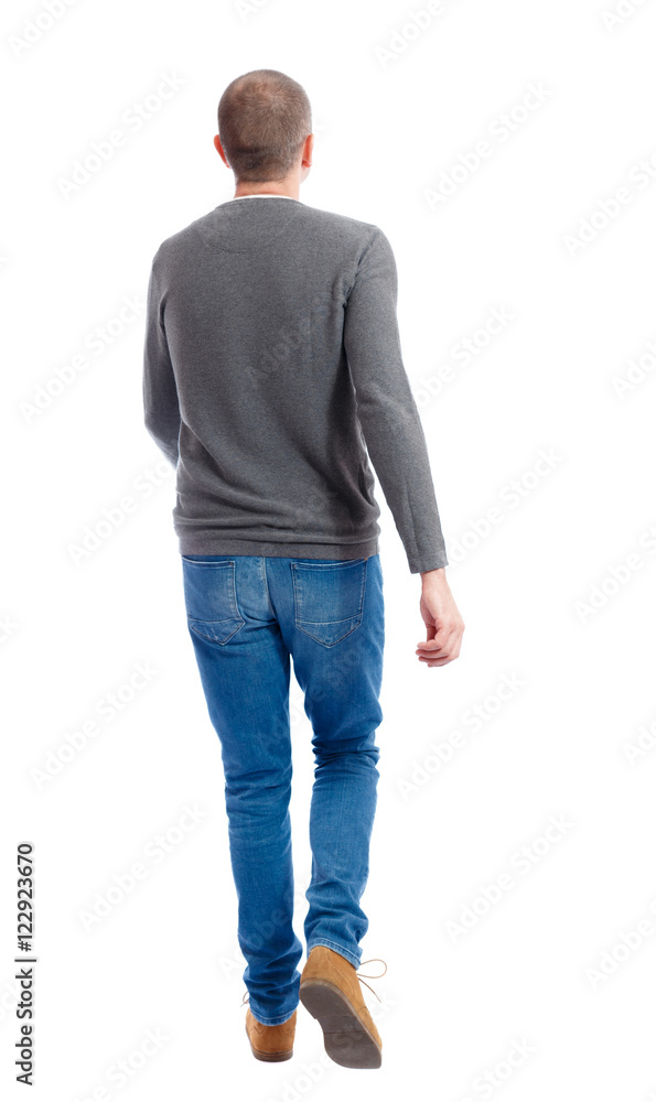 Back view of going handsome man. walking young guy . Rear view people collection. backside view of person. Isolated over white background. A guy in a gray sweater walking waving his arms. Back view of going handsome man. walking young guy . Rear view people collection. backside view of person. Isolated over white background. A guy in a gray sweater walking waving his arms.