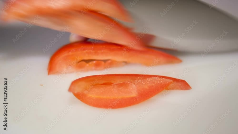 tomato cuts to slices on white background tomato cuts to slices on white background