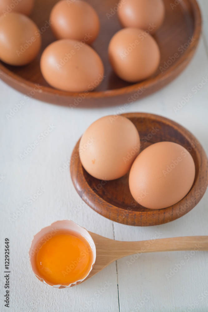 Egg in a wooden bowl on wooden table white. Chicken Egg. Top view with copy space Egg in a wooden bowl on wooden table white. Chicken Egg. Top view with copy space