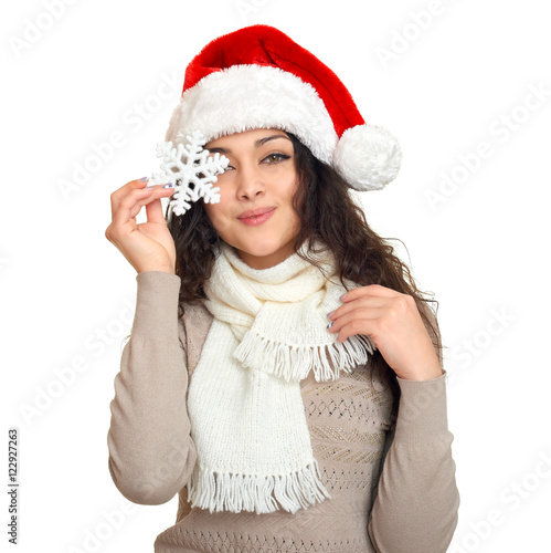 girl in santa hat portrait with snowflake posing on white background  christmas holiday concept  happy and emotions