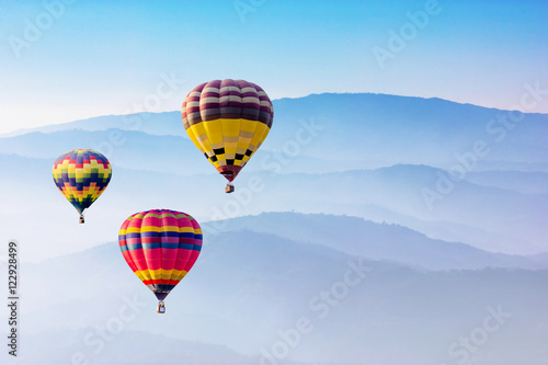 Colorful hot-air balloons flying over the mountain © artpritsadee