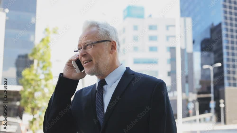 senior businessman calling on smartphone in city senior businessman calling on smartphone in city