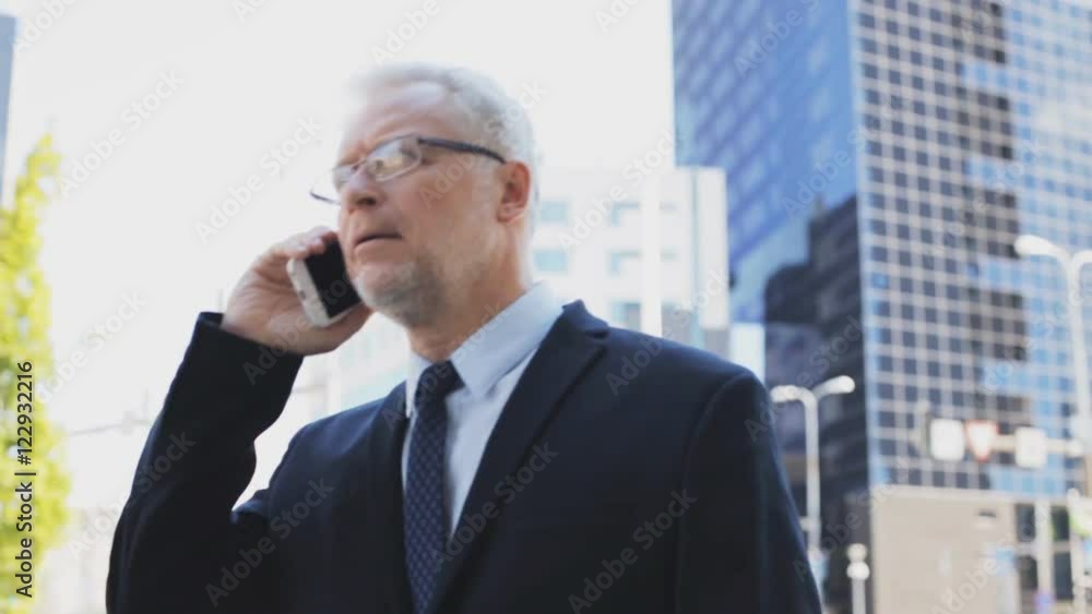 senior businessman calling on smartphone in city senior businessman calling on smartphone in city