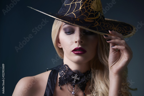 Sexy witch posing with hat © gpointstudio