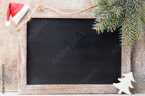 Christmas chalkboard with decoration. Santa hat, stars, Wooden