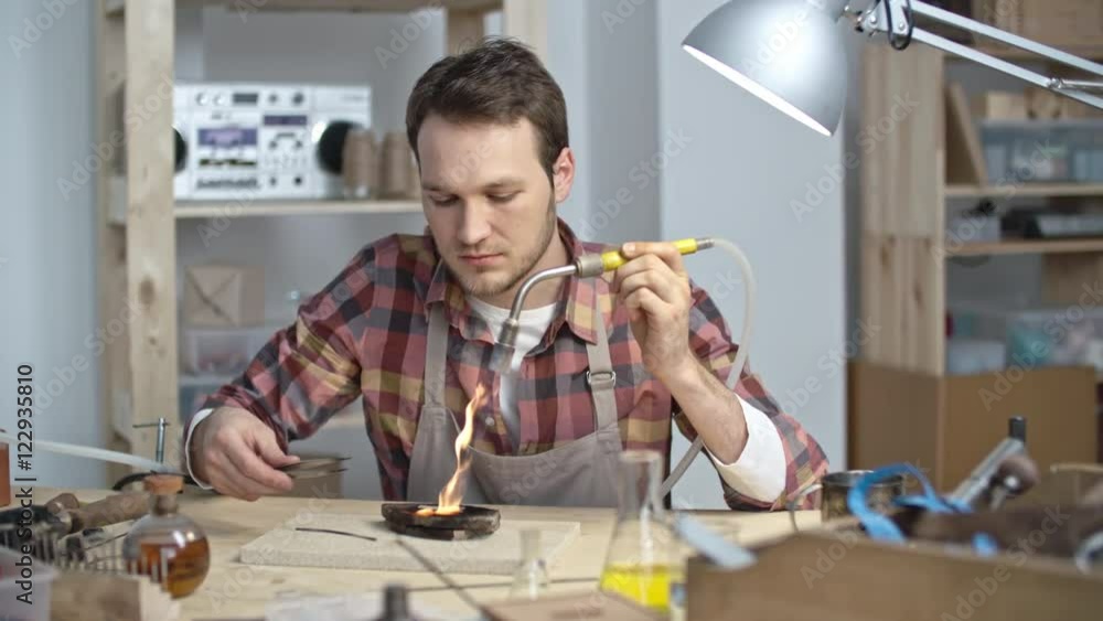 Professional jeweler lightning welding torch with lighter and using it for shaping precious metal Professional jeweler lightning welding torch with lighter and using it for shaping precious metal